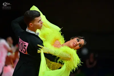 Dancesport competitor: Male dancer: black suit with a white shirt and a white bow tie