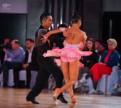 Dancesport competitor: Male dancer: black long-sleeved shirt with sequin detailing on the sleeve and bl