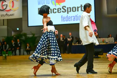 Dancesport competitor: Female dancer: navy blue skirt with large white polka dots, black strapless bodi