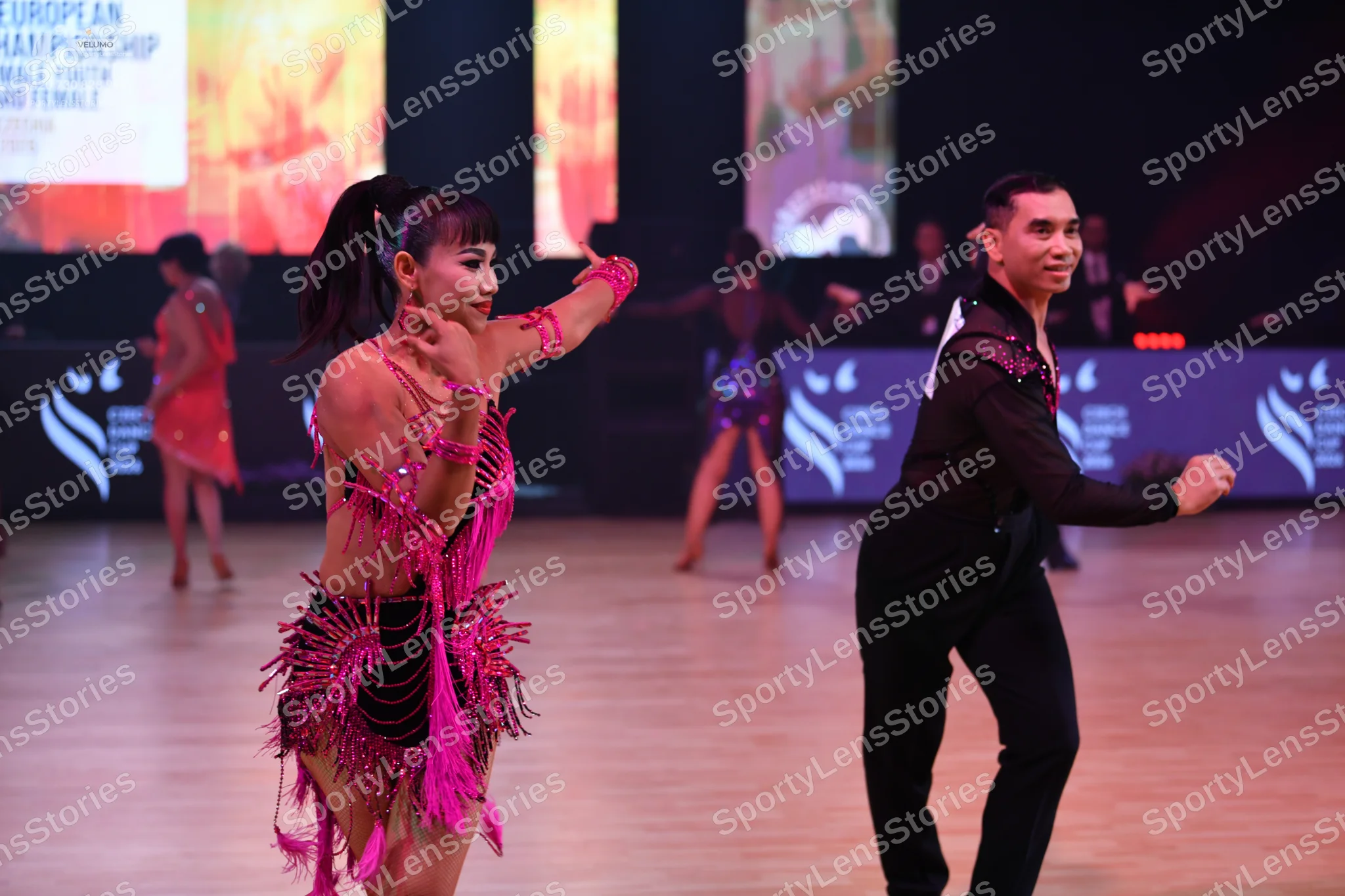 Dancesport competitor: Male dancer: black long-sleeved shirt with silver/white sequin accents on the sh