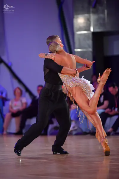 Dancesport competitor: Male dancer: black long-sleeved shirt and black trousers