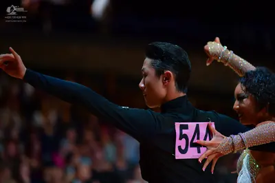 Dancesport competitor: Male dancer: black long-sleeved top