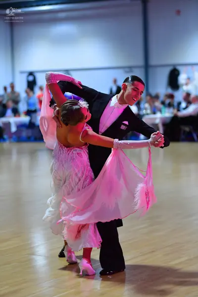 Dancesport competitor: Male dancer: black suit with a white shirt
