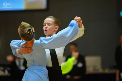 Dancesport competitor: Female dancer: light blue long-sleeved dress with a smooth, matte fabric