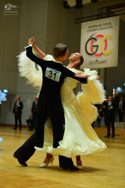Dancesport competitor: Male dancer: black long-sleeve top and black trousers