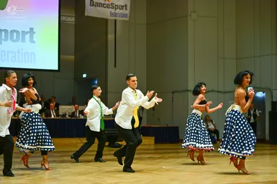 Dancesport competitor: Male dancers: white button-down shirts with black trousers and colored ties (pin