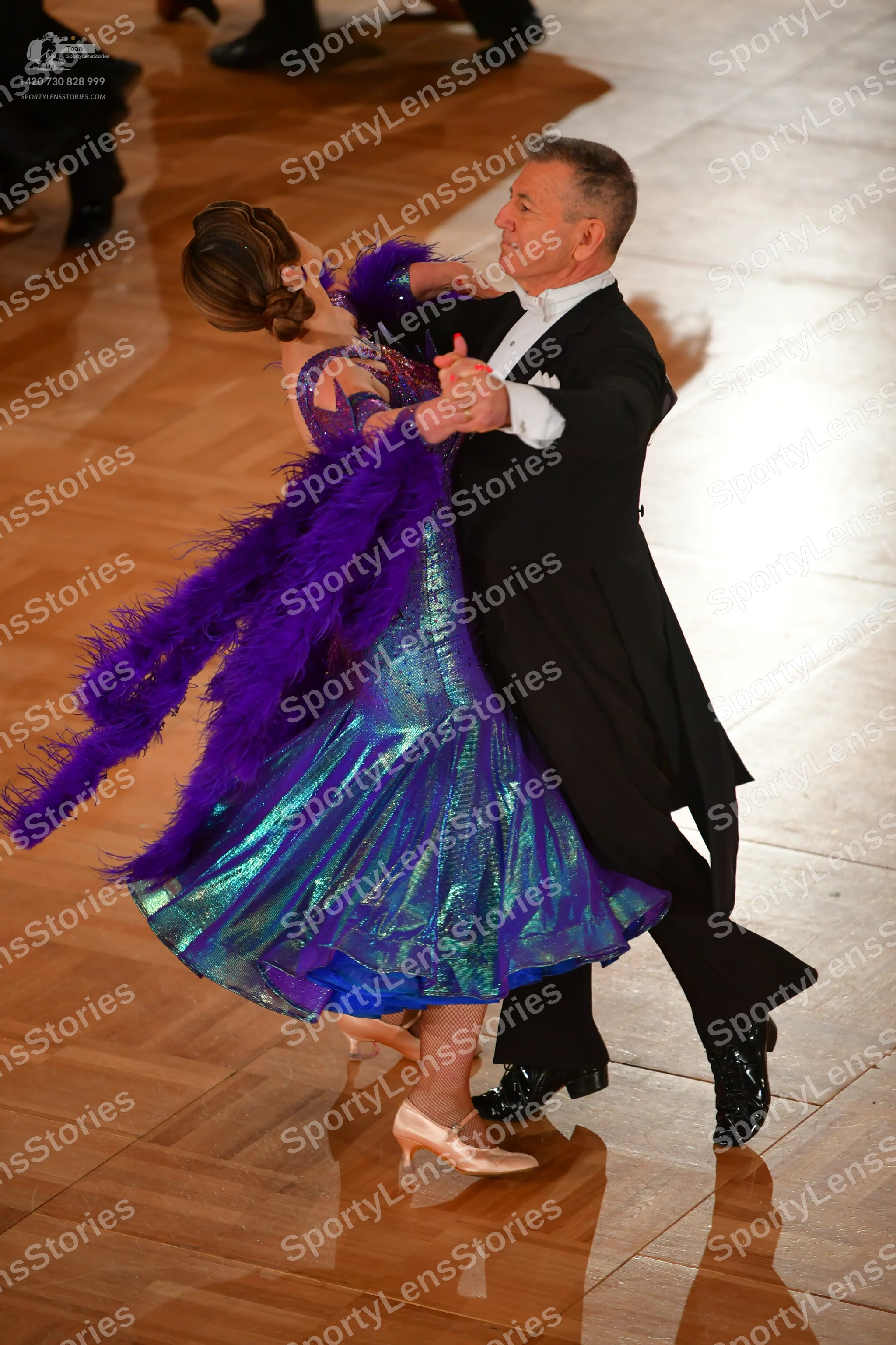 Dancesport competitor: Male dancer: black tailcoat, white dress shirt, black trousers, and black patent