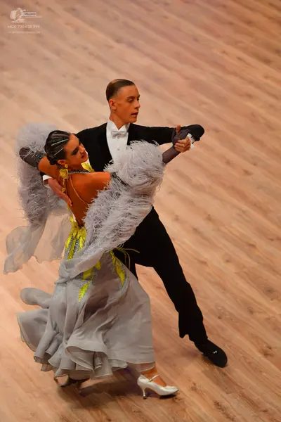 Dancesport competitor: Male dancer: black suit with white shirt and white bow tie