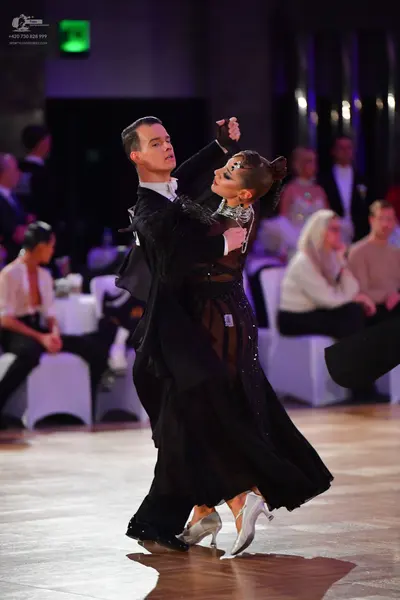 Dancesport competitor: Male dancer: black ballroom suit with a white shirt and black shoes