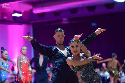 Dancesport competitor: Main male dancer: black long-sleeved shirt with a white undershirt