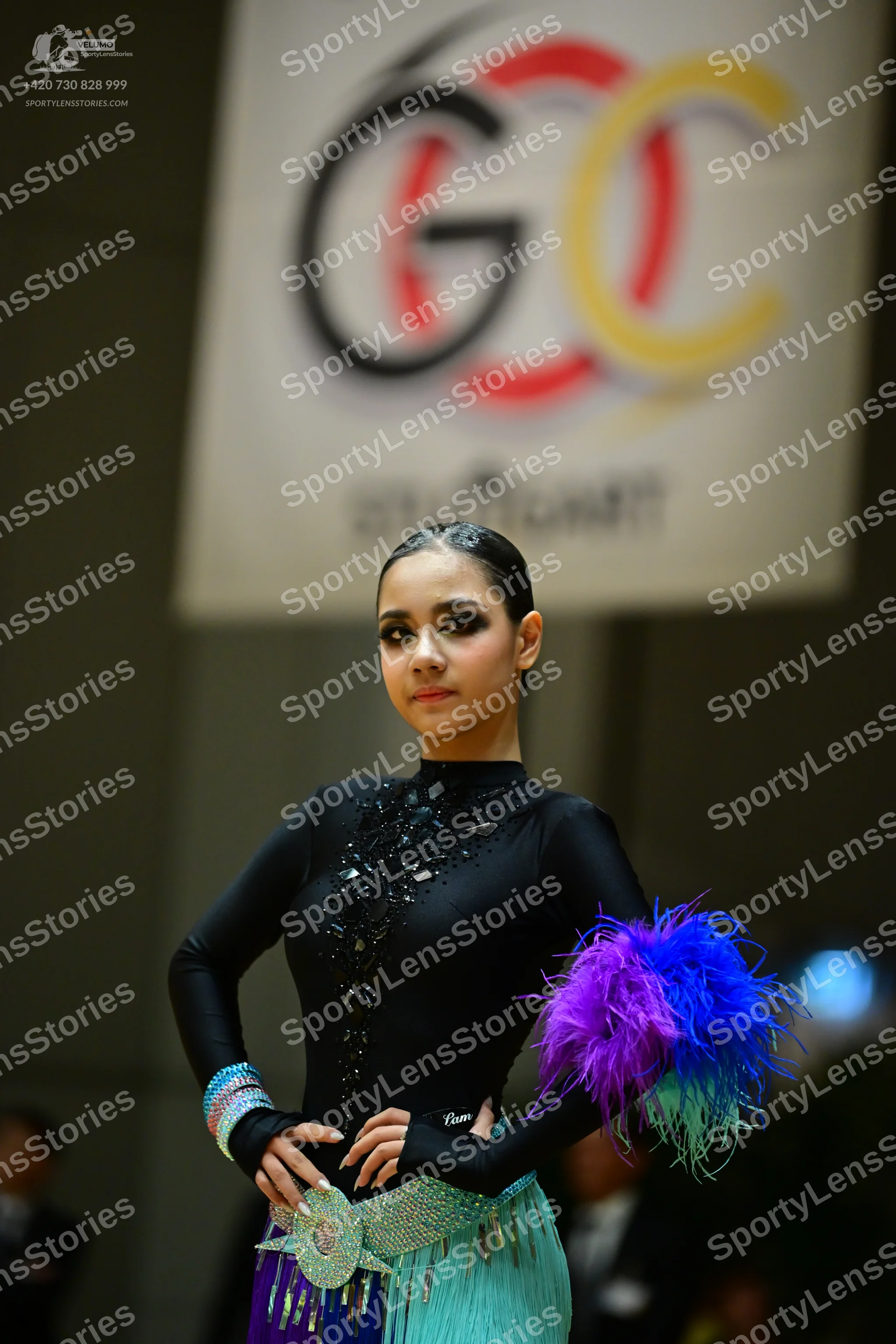 Dancesport competitor: Female dancer: black long-sleeved high-neck Latin-style top with black sequins/b