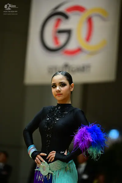 Dancesport competitor: Female dancer: black long-sleeved high-neck Latin-style top with black sequins/b