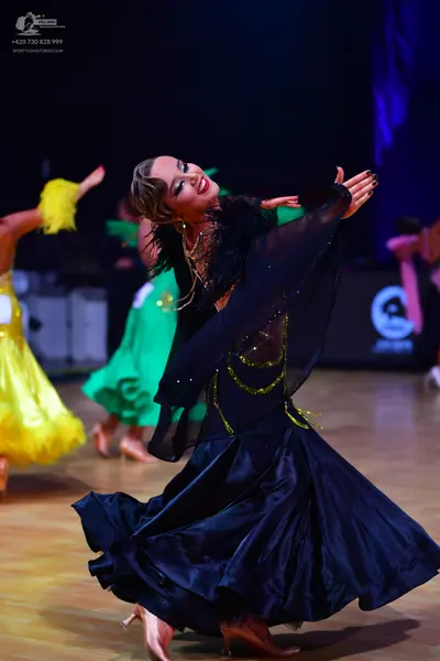 Dancesport competitor: Main dancer: black ballroom dress with a voluminous satin skirt and a sheer bodi