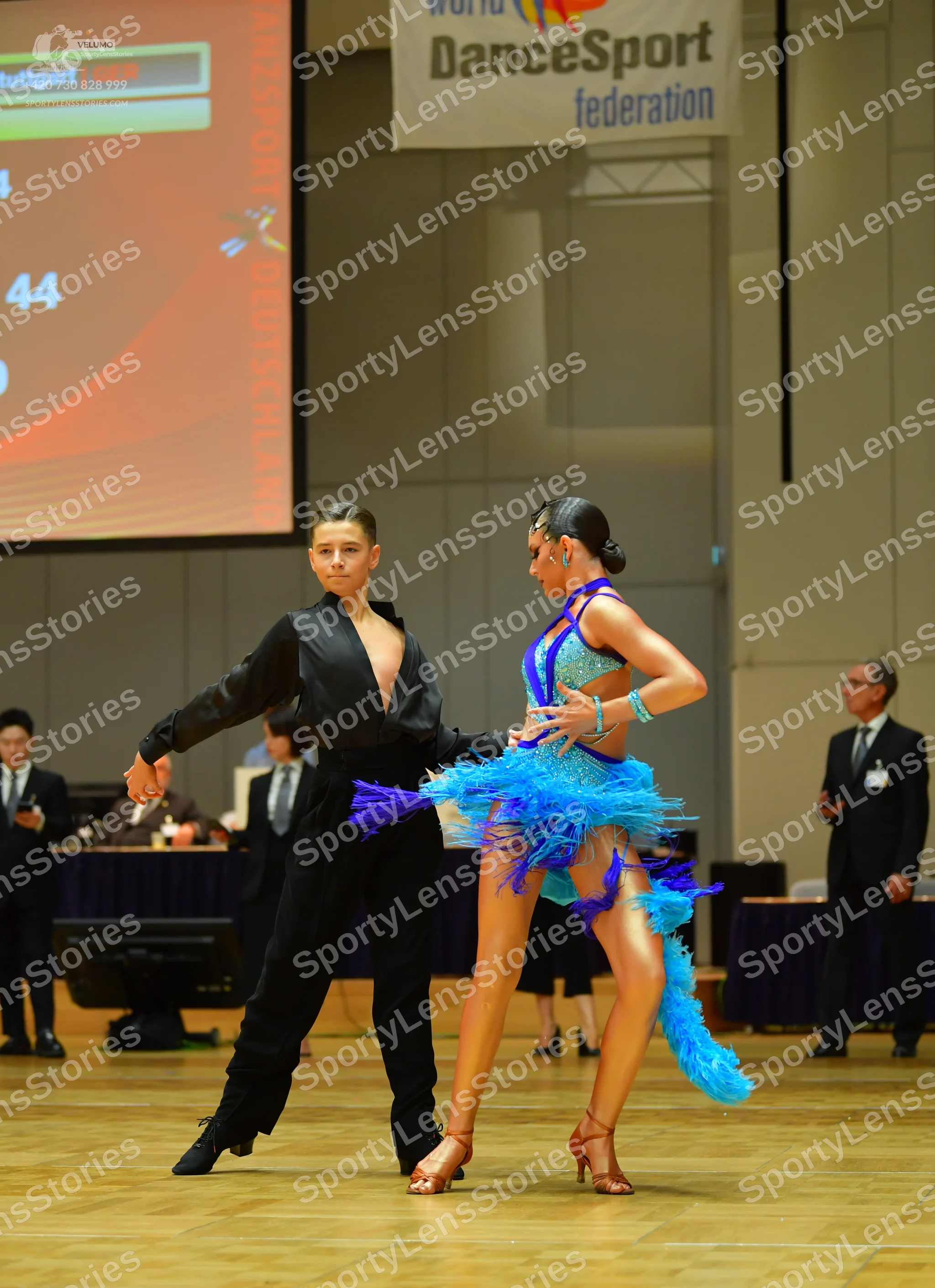 Dancesport competitor: Male dancer: black long-sleeved shirt with a deep V-neck and black trousers