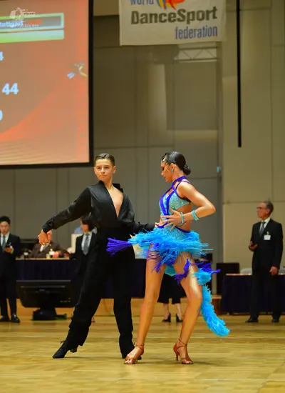 Dancesport competitor: Male dancer: black long-sleeved shirt with a deep V-neck and black trousers