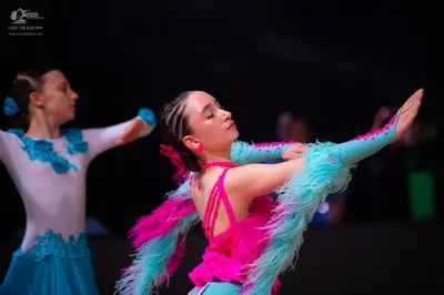 Dancesport competitor: Female dancer 1: white and blue Latin dance dress with blue lace/applique patter
