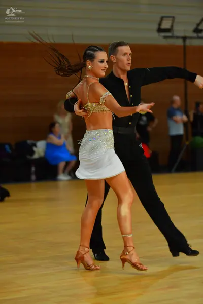 Dancesport competitor: Male dancer: black long-sleeved shirt with small crystal embellishments and blac