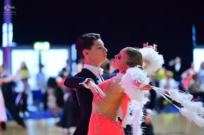 Dancesport competitor: Male dancer: black suit with a white shirt and white bowtie