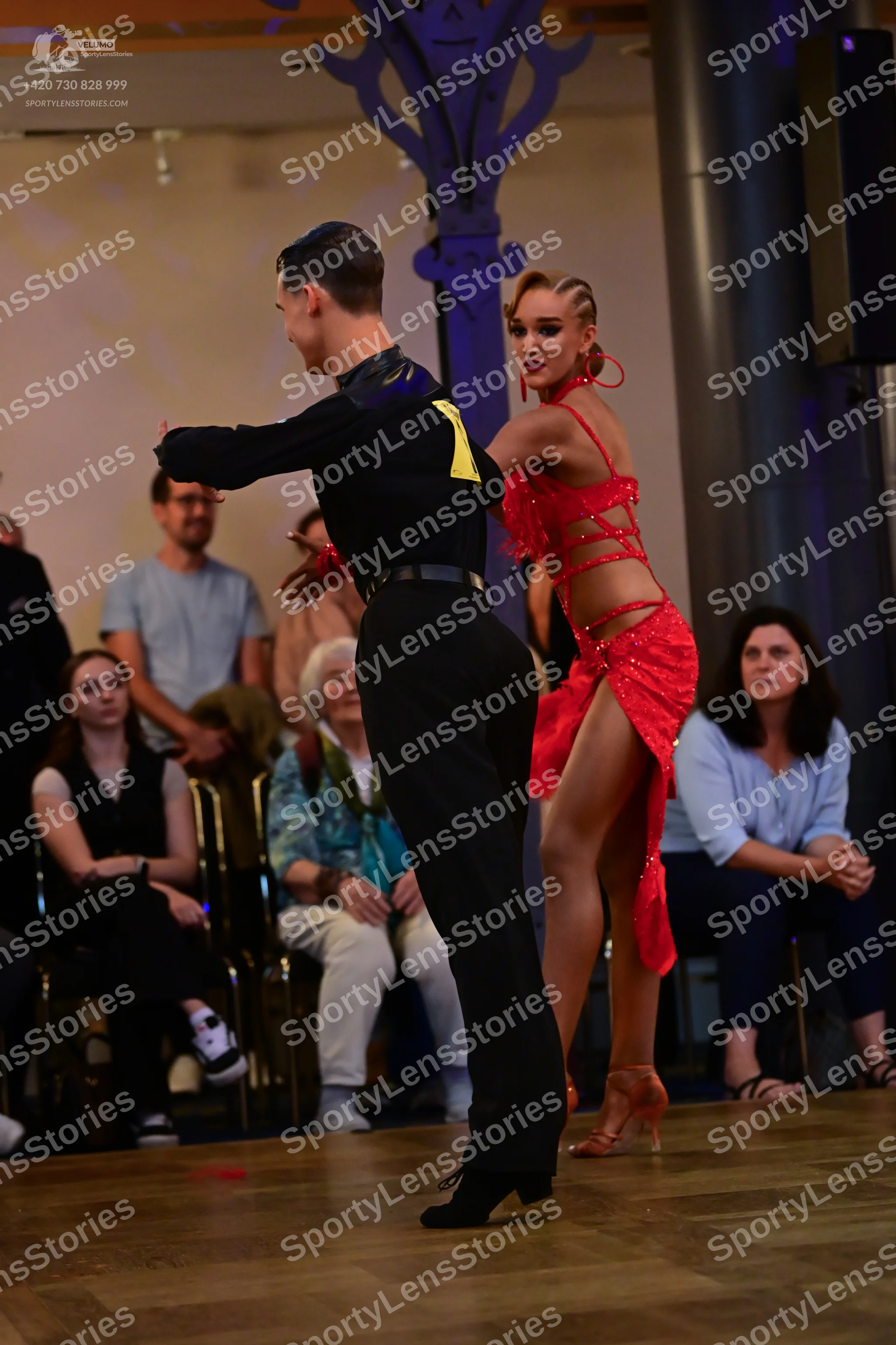 Dancesport competitor: Male dancer: black long-sleeved shirt with yellow detail on the shoulder and bla