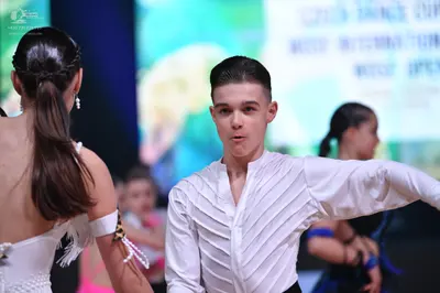Dancesport competitor: Male dancer: white long-sleeved Latin shirt with textured, pleated front