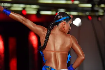 Dancesport competitor: Female dancer: blue sequined Latin dance costume with blue fringe, featuring a b