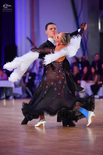 Dancesport competitor: Male dancer: black suit, white shirt, and black bow tie