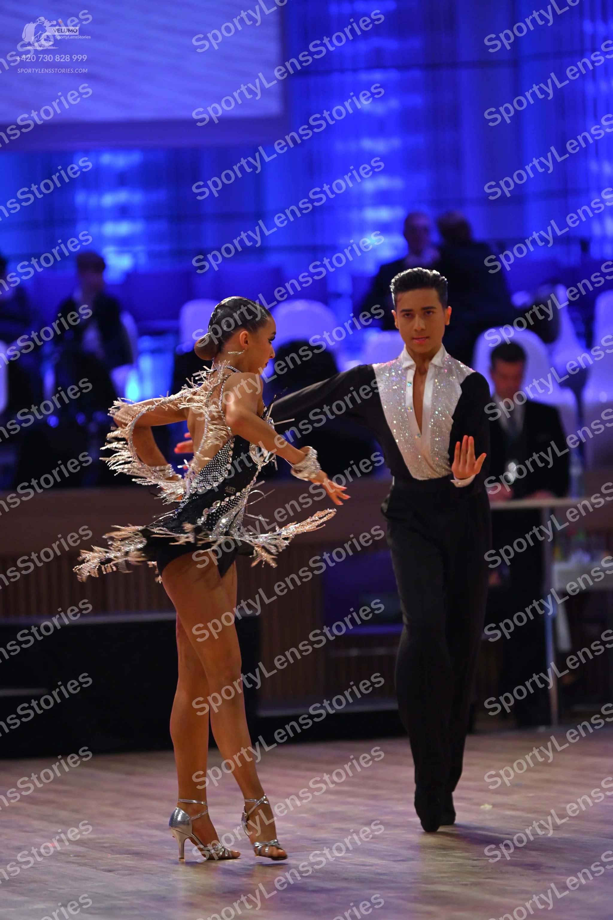 Dancesport competitor: Male dancer: black long-sleeved shirt with a white/silver sequined front panel a