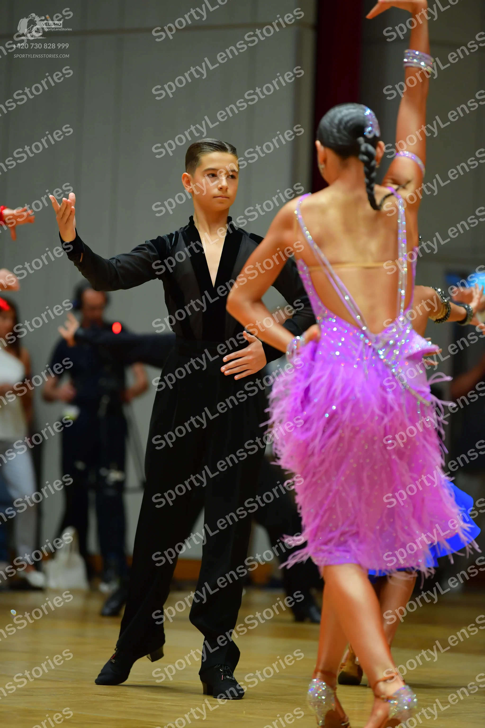 Dancesport competitor: Male dancer: black long-sleeved shirt with a deep V-neck and black trousers