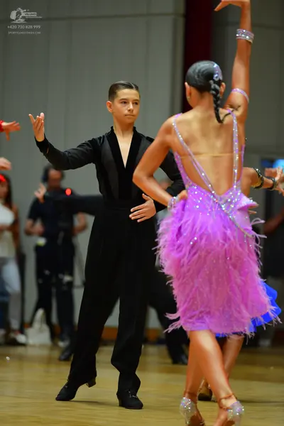 Dancesport competitor: Male dancer: black long-sleeved shirt with a deep V-neck and black trousers