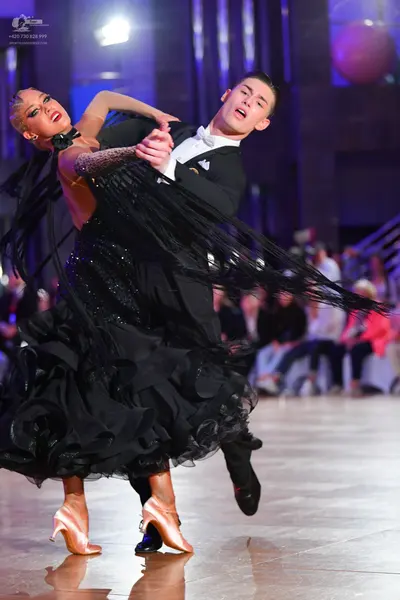 Dancesport competitor: Male dancer: black suit with white shirt and white bow tie