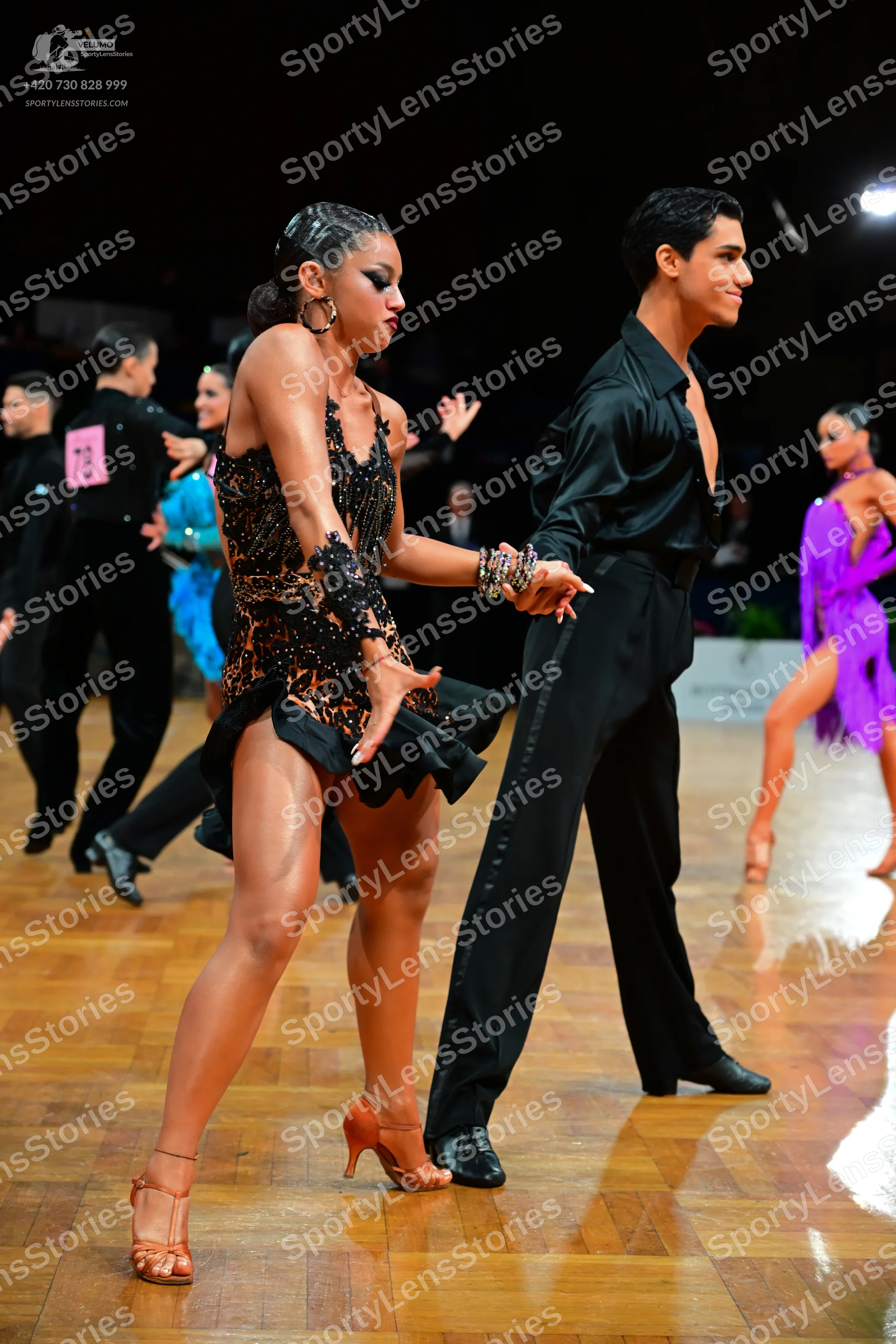 Dancesport competitor #78: Male dancer in foreground: black long-sleeved shirt and black trousers