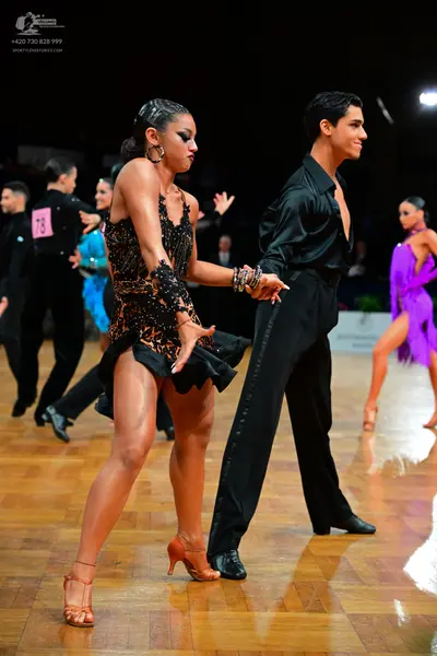 Dancesport competitor #78: Male dancer in foreground: black long-sleeved shirt and black trousers