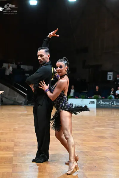 Dancesport competitor: Male dancer: black long-sleeved shirt and black trousers