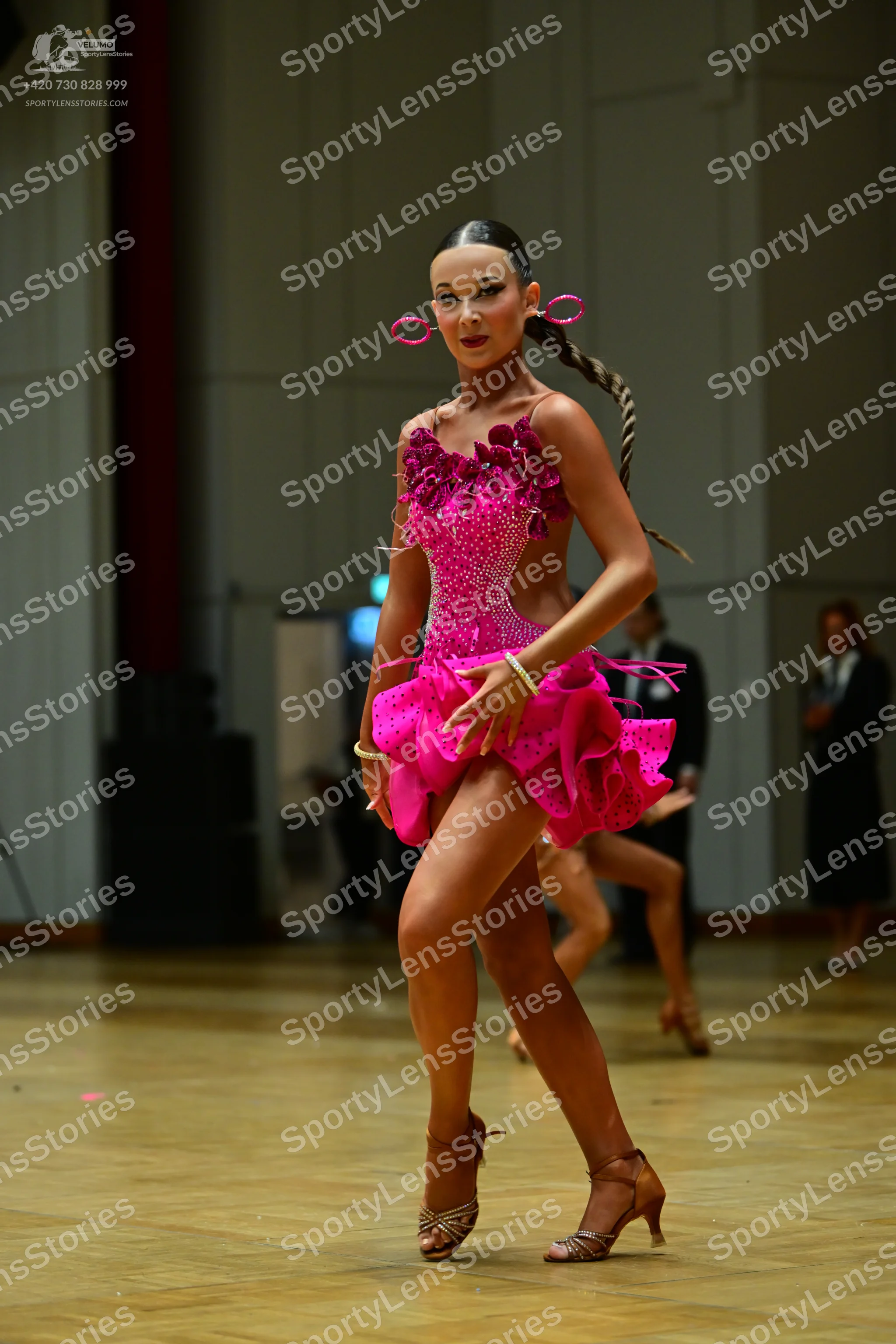 Dancesport competitor: Female dancer: bright pink latin dance dress, heavily embellished with sequins a