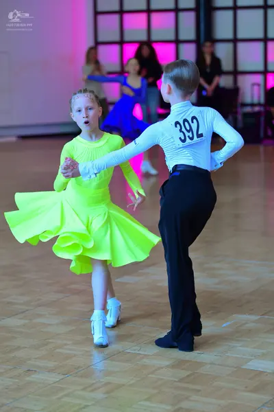 Dancesport competitor #392: Male dancer: white long-sleeved shirt with black number 392 and black trousers