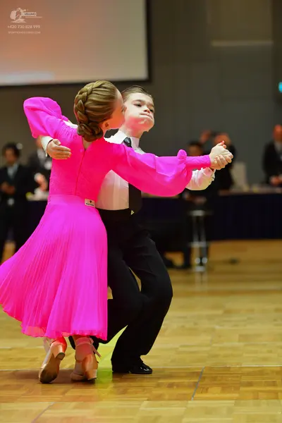 Dancesport competitor: Male dancer: white long-sleeved shirt, black necktie, and black trousers