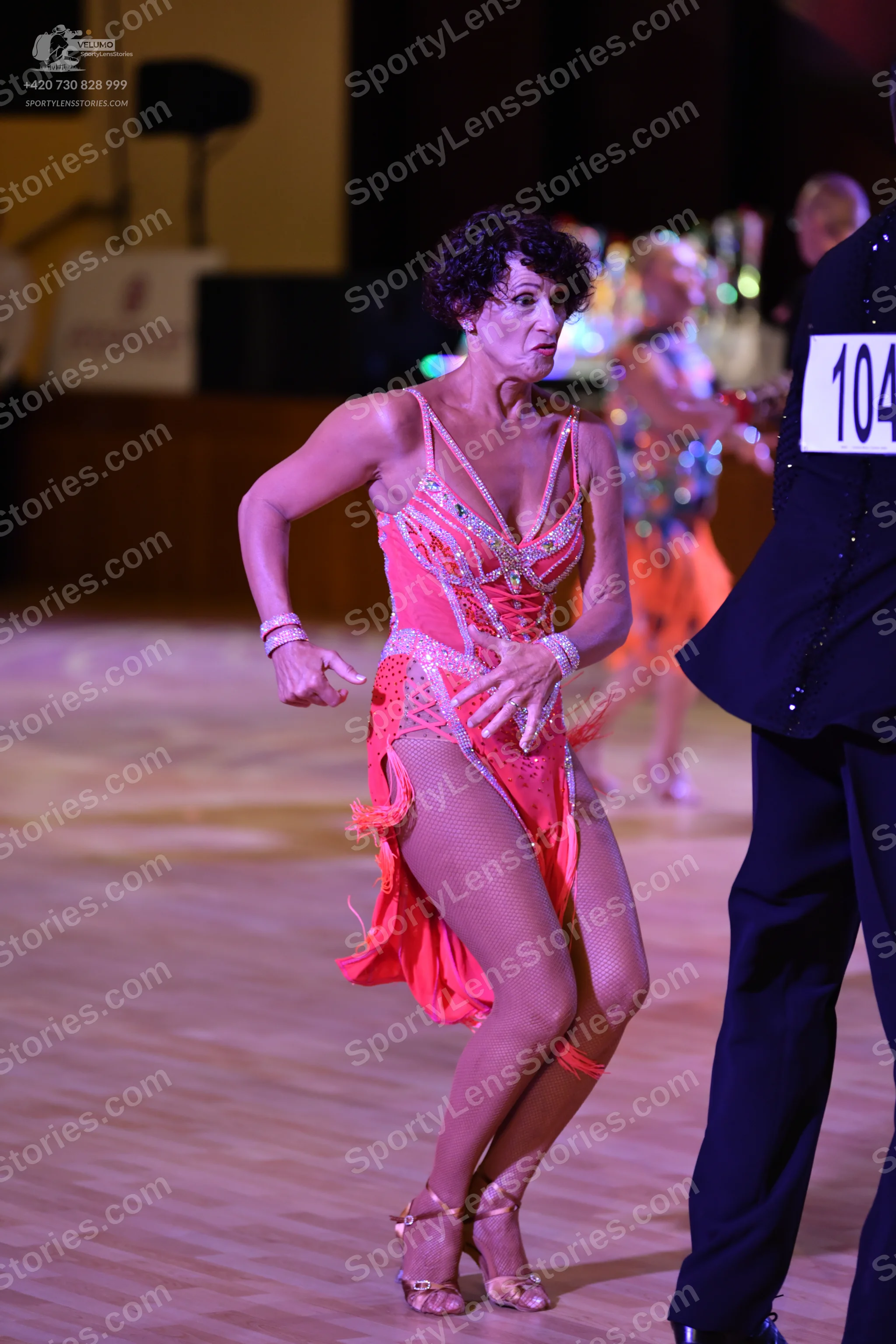 Dancesport competitor: ** Red Latin Dress
*   **Color:** Bright Red
*   **Fabric:** Crinoline base with