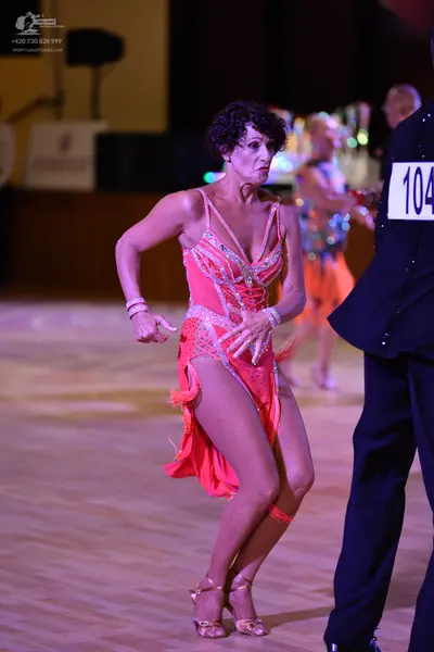 Dancesport competitor: ** Red Latin Dress
*   **Color:** Bright Red
*   **Fabric:** Crinoline base with