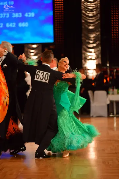 Dancesport competitor #630: Male dancer in center: black tailcoat, white shirt, and black trousers