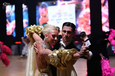 Dancesport competitor: Female dancer: gold/champagne-colored dance dress with heavy sequin and crystal 