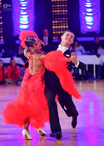 Dancesport competitor: Male dancer: black suit with a white shirt and white bow tie