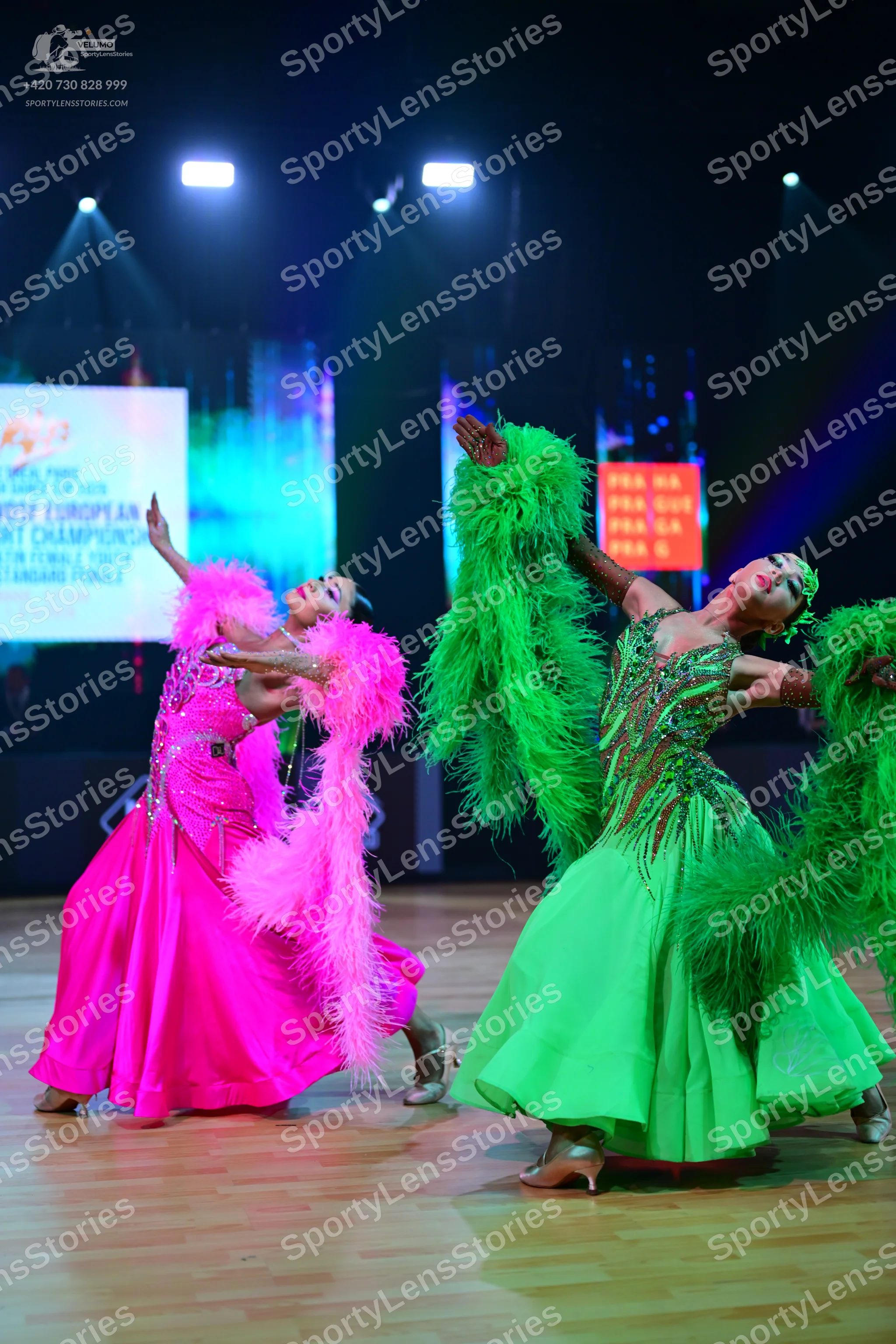 Dancesport competitor: Female dancer 1: bright pink ballgown with a large, fluffy pink feather boa arou