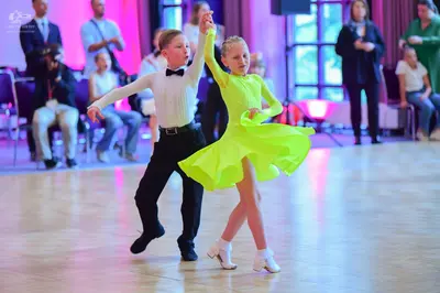 Dancesport competitor: Male dancer: white long-sleeved shirt, black bow tie, and black trousers