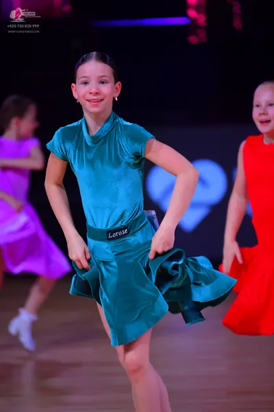 Dancesport competitor: Female dancer in center: teal satin short dress with a high neck and short sleev