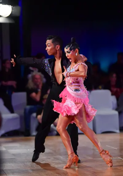 Dancesport competitor: Male dancer: black long-sleeved shirt with a sequin panel on the chest and black