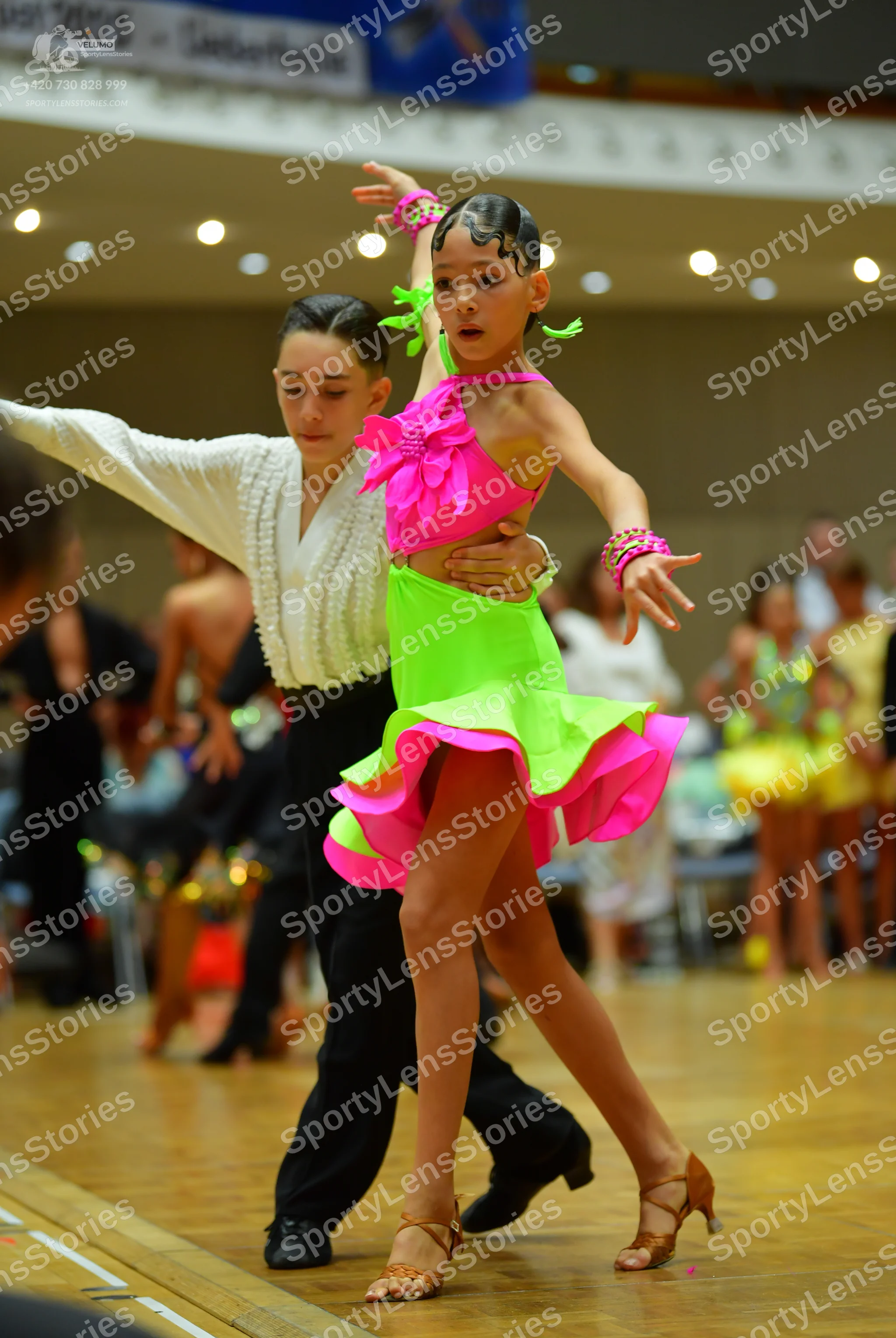 Dancesport competitor: Male dancer: white long-sleeved shirt with a textured front, black trousers, and