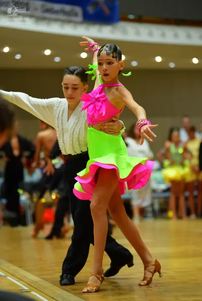 Dancesport competitor: Male dancer: white long-sleeved shirt with a textured front, black trousers, and