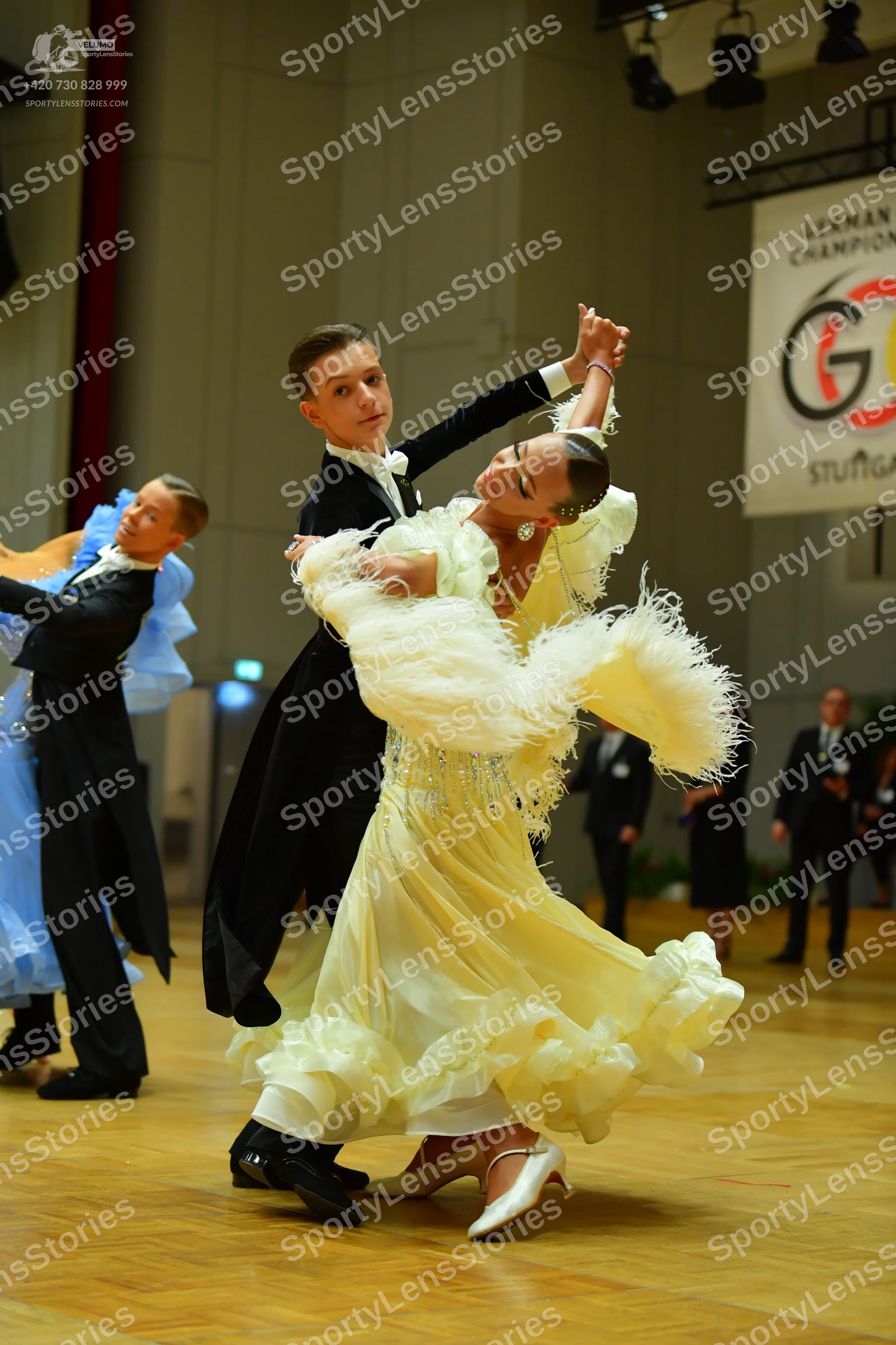 Dancesport competitor: Male dancer: black long-sleeved shirt with white collar and black trousers