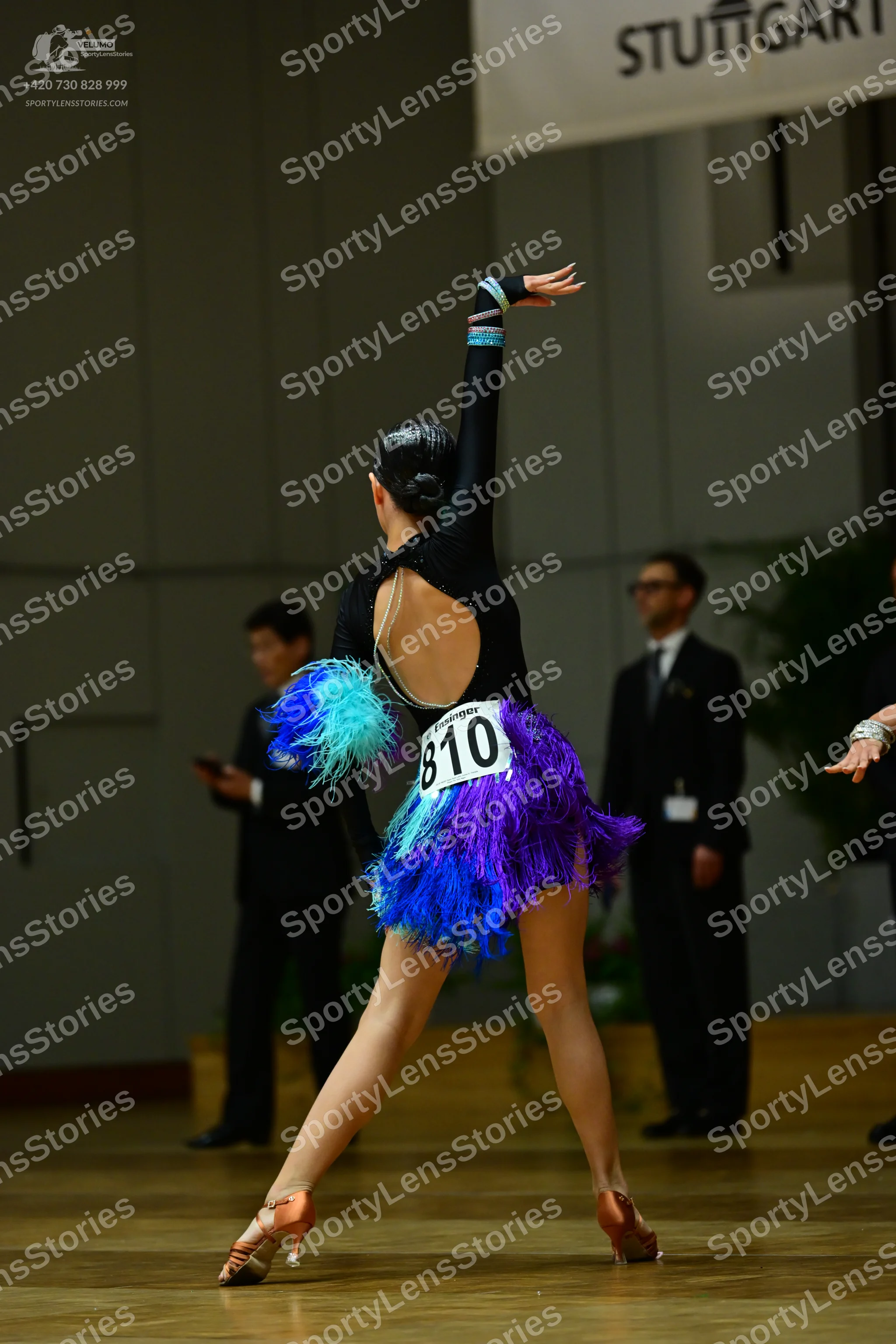 Dancesport competitor #810: Female dancer: black Latin dress with an open back and a vibrant blue and purple