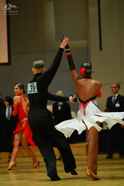 Dancesport competitor: Male dancer: black long-sleeved shirt and black trousers